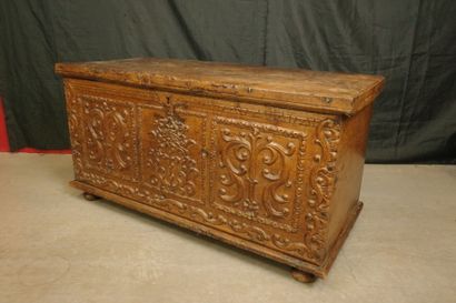 Natural wood cabinet with a carved three-panel...