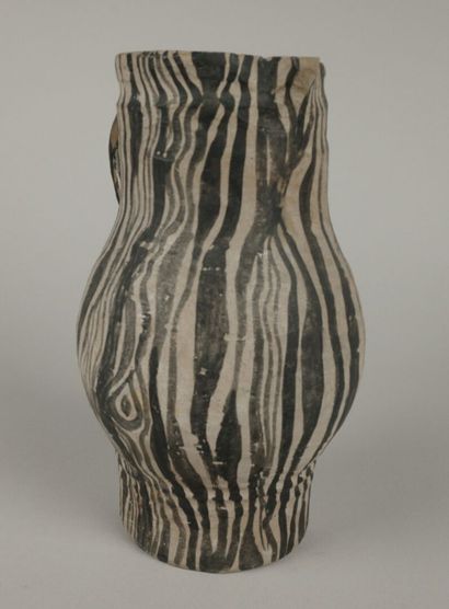 Gray ceramic carafe designed to resemble...