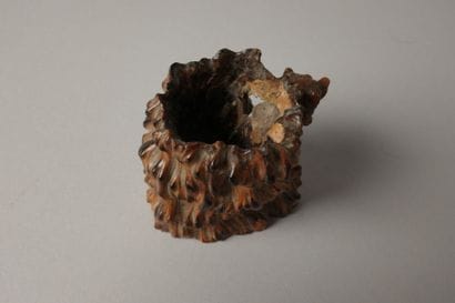 A finely carved boxwood match holder featuring...
