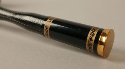 Black nylon parasol, with a black leather-covered...