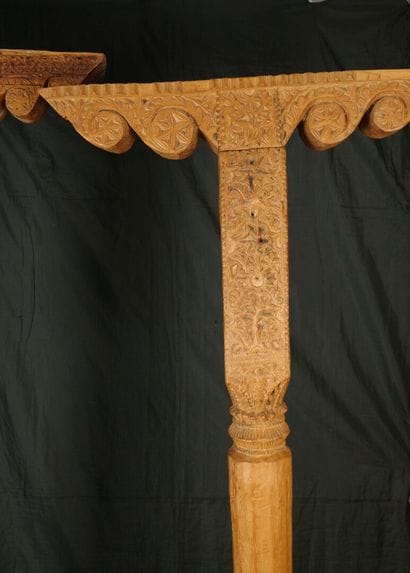 Two carved pine columns with consoles decorated...