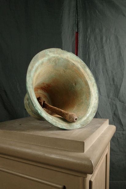 Large bronze bell decorated with angel heads...
