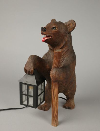 Painted, carved wooden bear with a lantern
That...