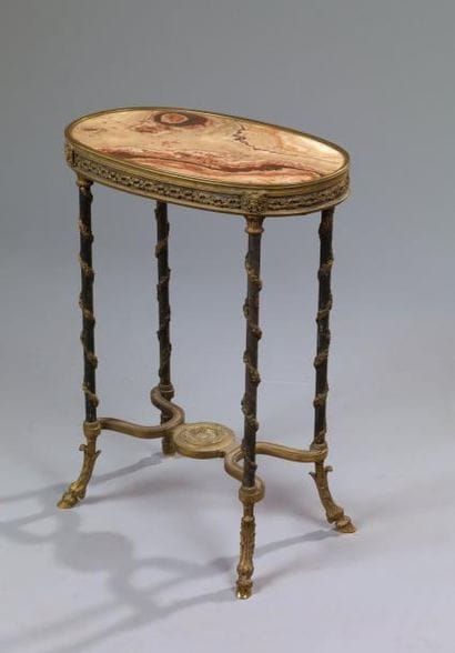 Table ovale en bronze ciselé et doré, acier...