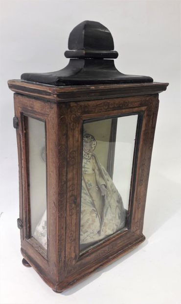 Small showcase in natural wood opening to...