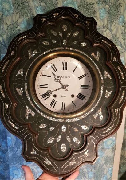 Clock of type eye of ox in black tinted wood...