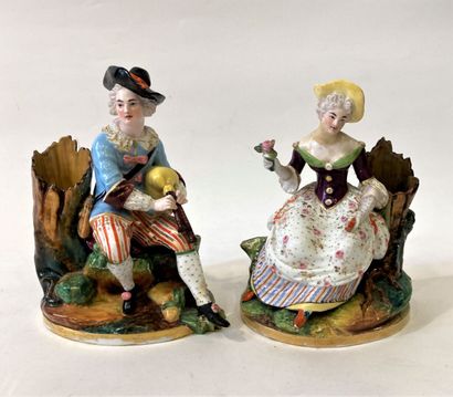 Pair of polychrome porcelain groups featuring...