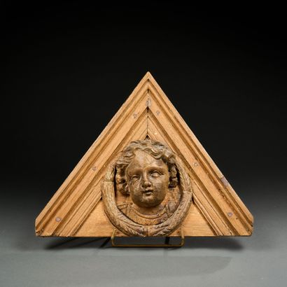 Molded wood pediment decorated in the center...