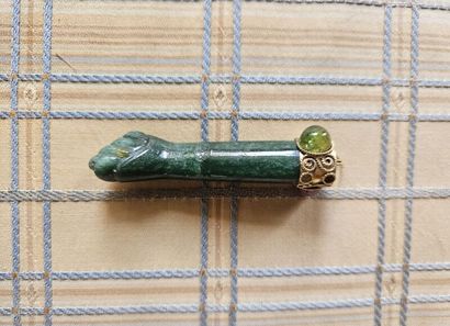 Hard stone pendant depicting a forearm with...