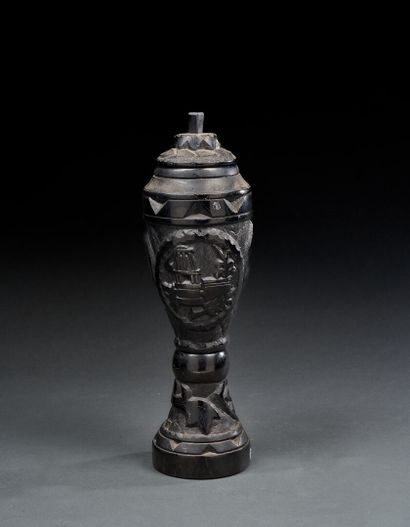 Urn carved in charcoal depicting masks and...