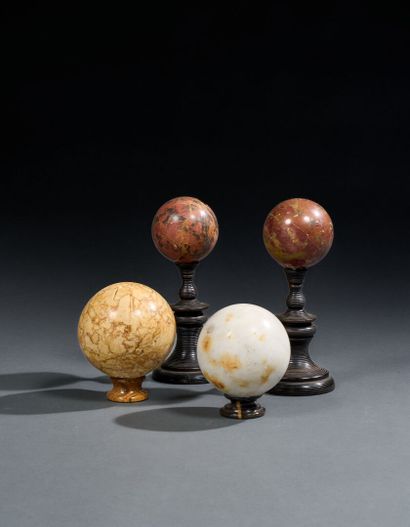 Set of four marble and jasper balls on turned...