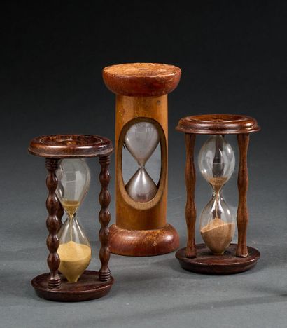 Set of three turned wood table hourglasses
One...
