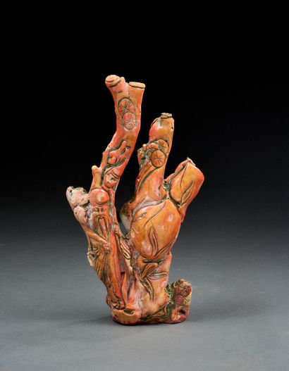 Branch carved on fossilized orange coral...