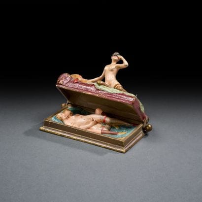 Bronze depicting a woman on a bed with a...
