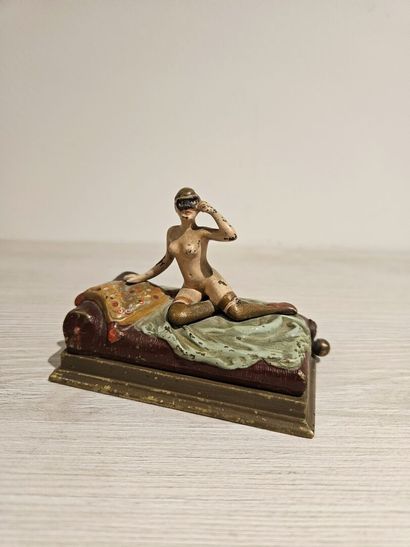 Bronze depicting a woman on a bed with a...