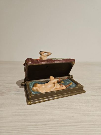 Bronze depicting a woman on a bed with a...