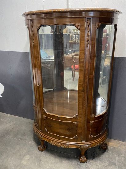Half-moon display case in natural wood opening...