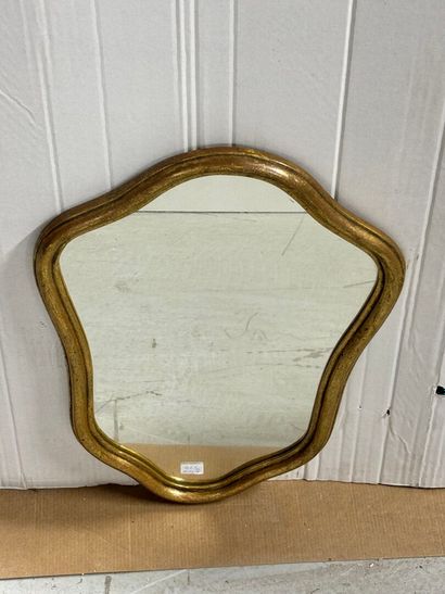 Wooden mirror with gilded trim and a shield-shaped...