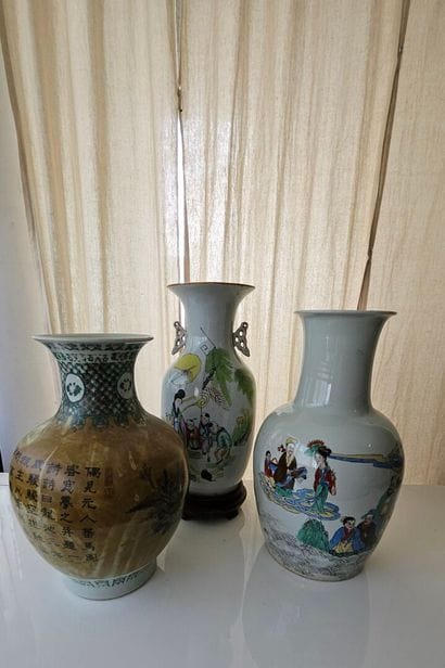 Set of three oval porcelain vases decorated...