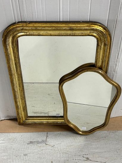 Wooden mirror with gilded trim and a shield-shaped...