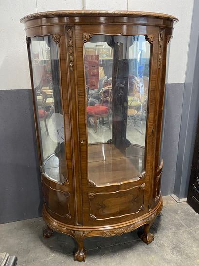 Half-moon display case in natural wood opening...