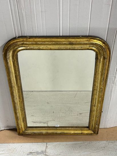 Wooden mirror with gilded trim and a shield-shaped...