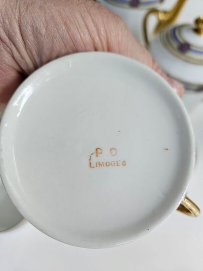 A white and gold porcelain coffee set decorated...