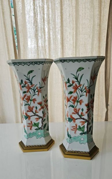 Pair of white-ground porcelain conical vases...