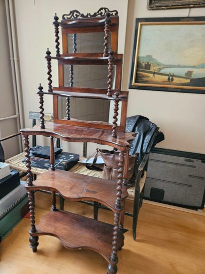 A mahogany shelf with an undulating shape,...