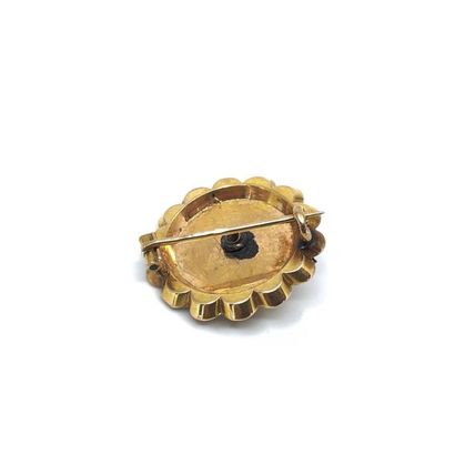 BROCHE ronde en or jaune 750° ornée d'une...