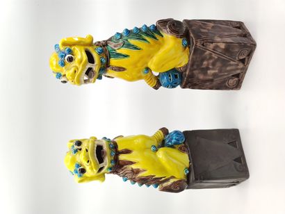TWO polychrome enamelled porcelain dogs of...