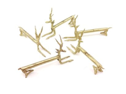 DOUZE porte-couteaux en bronze représentant...