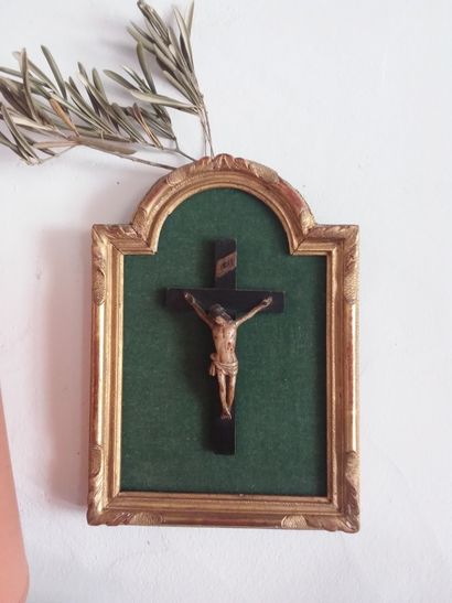 Crucifix en bois polychrome dans un cadre...