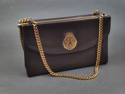 DUC

Sac à main en cuir marron et doré

De...