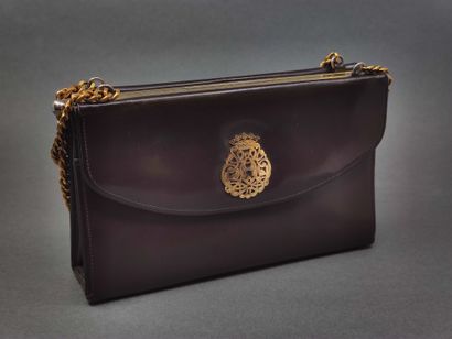 DUC

Sac à main en cuir marron et doré

De...