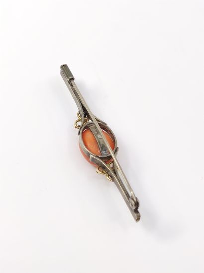 Gold and silver pin set with a coral cabochon...
