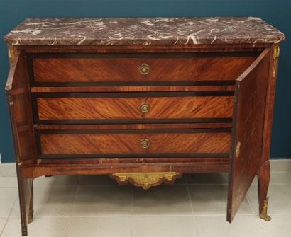 A rosewood veneer chest of drawers decorated...