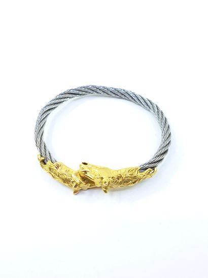 BRACELET in gold and steel topped by two...