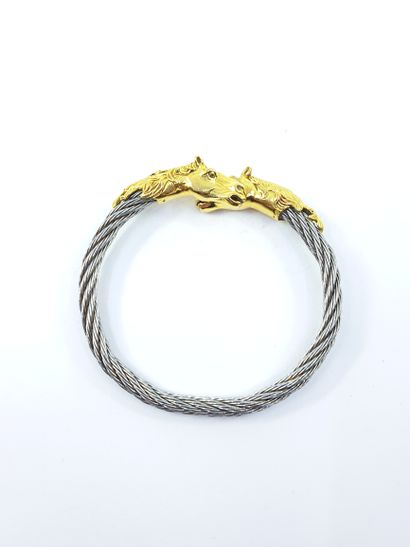 BRACELET in gold and steel topped by two...