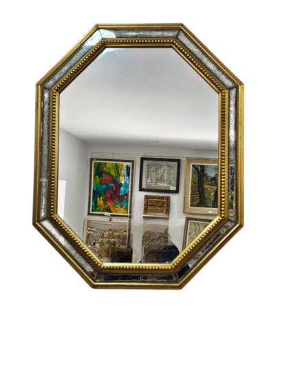 Octagonal wood and gilded stucco mirror with...