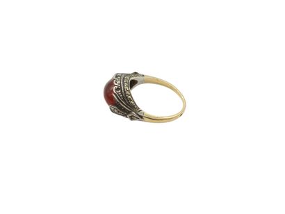 Gold and silver ring set with an orange stone...