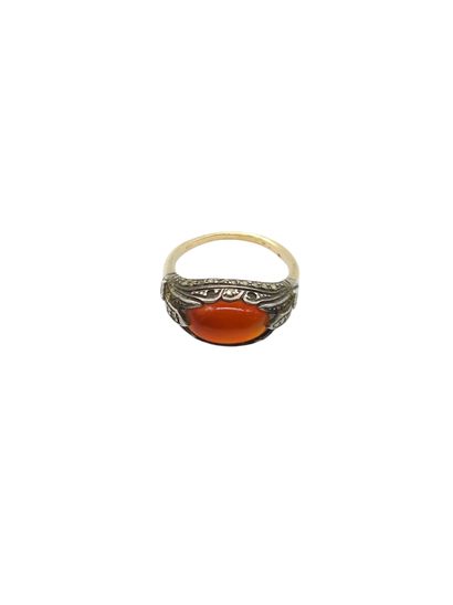 Gold and silver ring set with an orange stone...