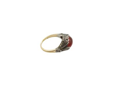 Gold and silver ring set with an orange stone...