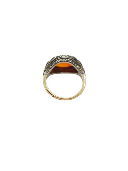 Gold and silver ring set with an orange stone...