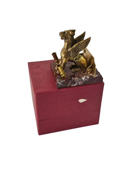 A pen holder in the shape of a mythological...