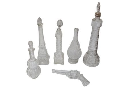 Set of nine blown glass bottles depicting...