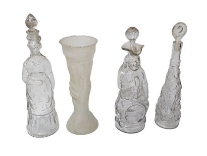 Set of nine blown glass bottles depicting...