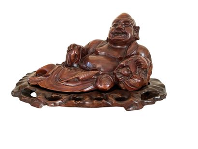 CHINA Reclining Buddha in carved wood, leaning...
