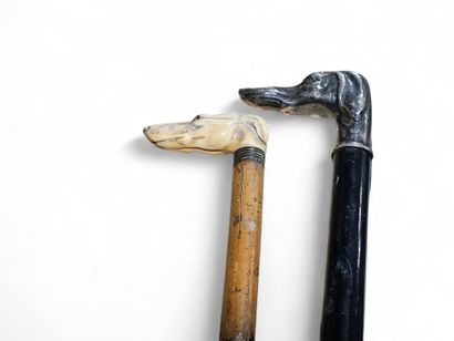 Two canes, knobs in the shape of a dog's...