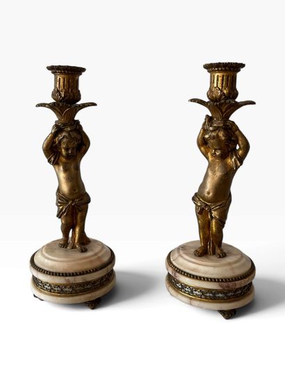 PAIR OF CANDLESTICKS decorated with cherubs,...